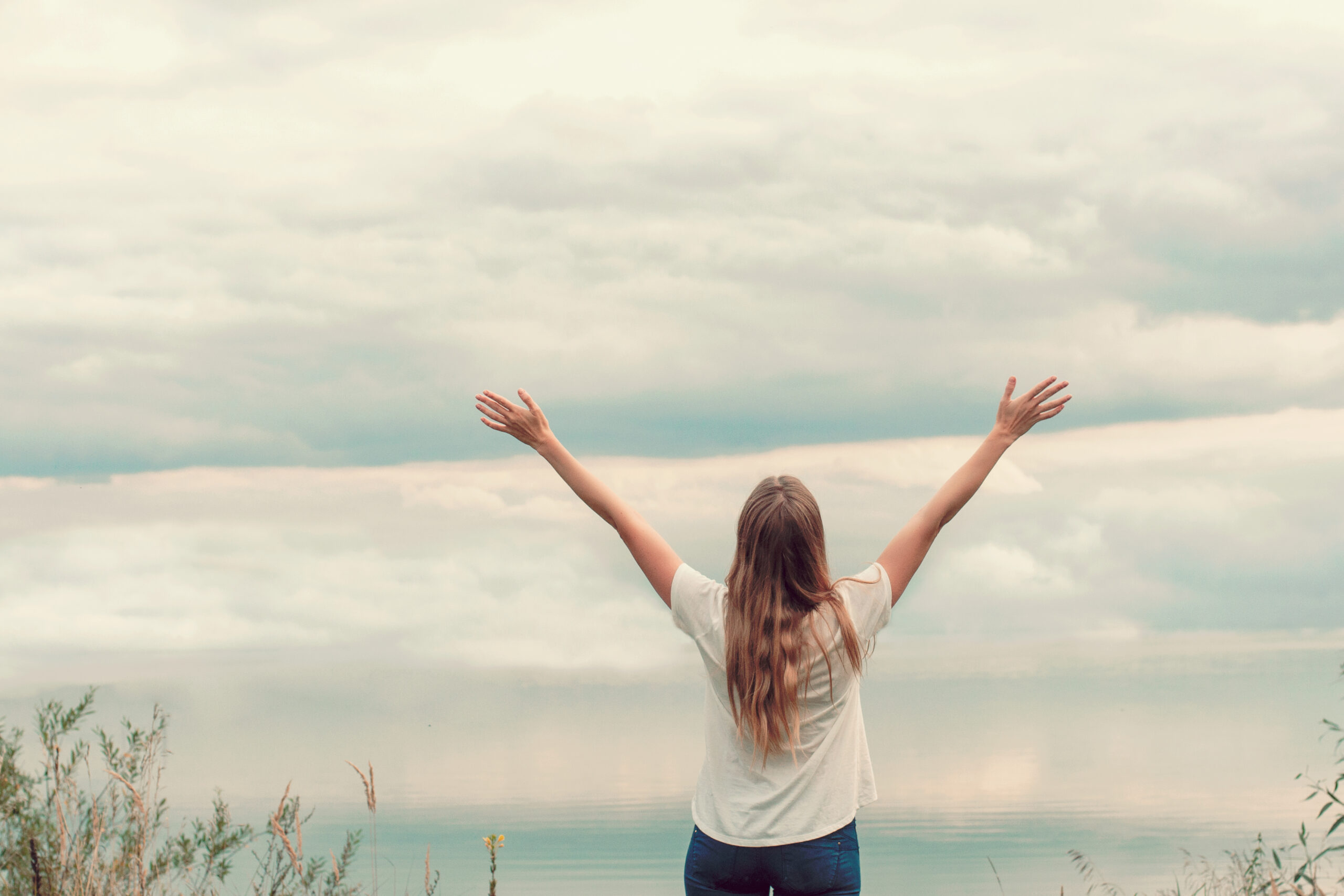 Woman feeling free, like view, cloudy sky
